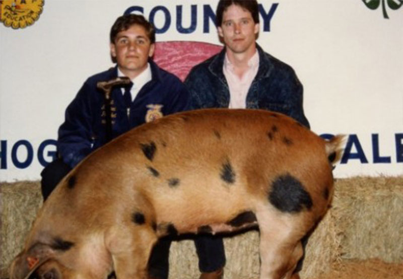 Photo of Wilton Simpson at the Fair Showing a Pig